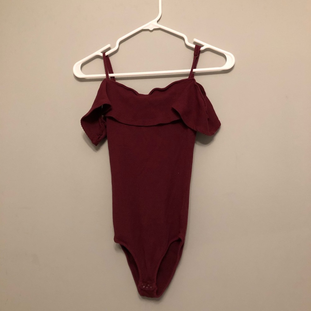 A tang top/ off the shoulder body suit